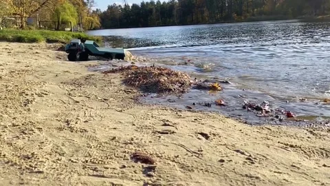 RC flatbed towing truck going on the pond shore sand and shallow water. Stock Footage 207415642