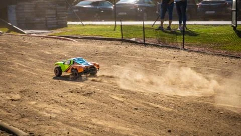RC shortcourse going down the main straight and leaving dust trail behind Stock Photos