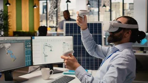 RD department researcher using VR headset to study solar clean energy systems Stock Photos