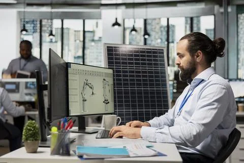 RD employee uses CAD software to optimize sustainable solar panel fabrication Stock Photos