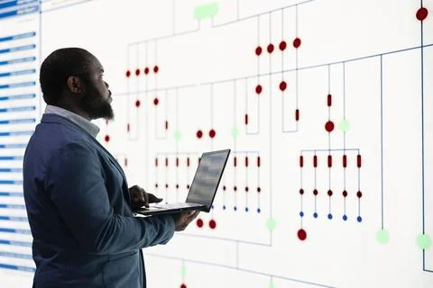 RD engineer oversees microprocessor plant production using laptop Stock Photos