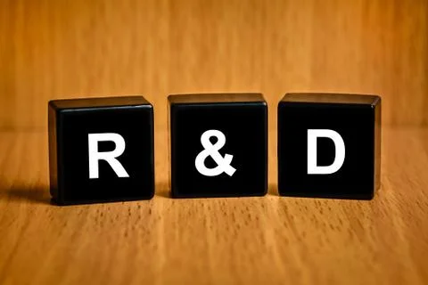 R&amp;d or research and development text on black block Stock Photos