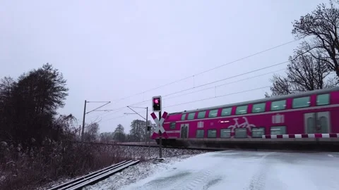 The RE 2 from Cottbus to Berlin in winter passing a railroad crossing Stock Footage 329066701