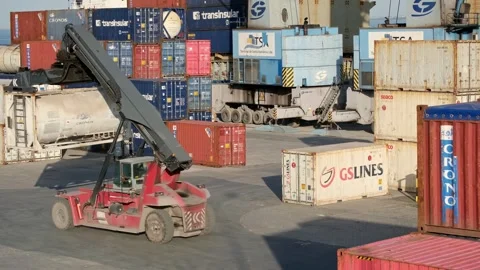 Reach stacker carry container in container area of port shipping yard Stock Footage 301306299