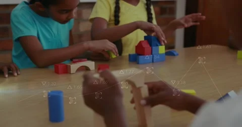 Reaching blocks, boy building yellow-holed tower, girl stacking blue blocks for Stock Footage 317799463
