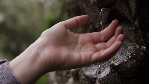 Reaching for Dripping Water Stock Footage 77196527