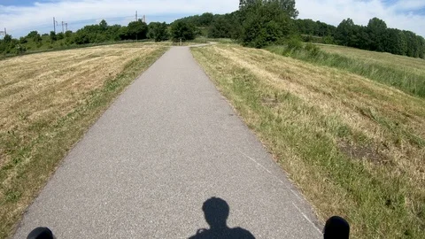 Reaching forked road on racing bicycle in summer time Stock Footage 98228831