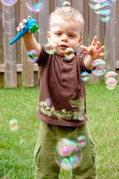 Reaching out for bubbles Stock Photos