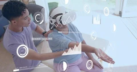 Reaching senior with VR headset in light-blue top pink-pants at home with AR Stock Photos