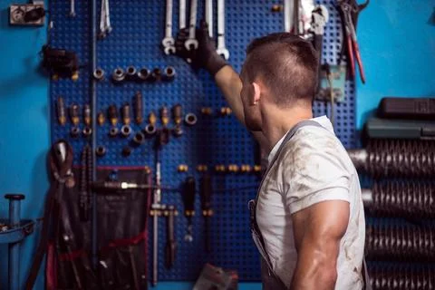 Reaching for wrench Stock Photos