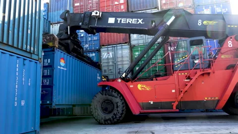 The reachstacker places a large container with other containers  Stock Footage 148691857