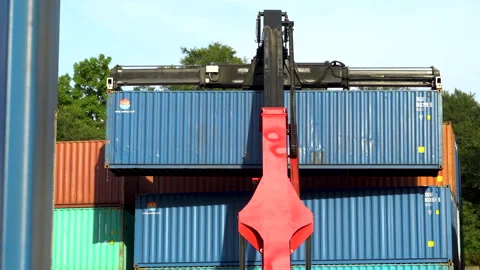 Reachstacker removes a container from other containers in an open-air logistics  Stock Footage 149468487
