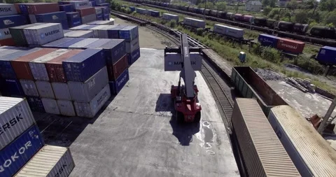 Reachstacker transports a container in the background of a logistics warehouse Stock Footage 148255534