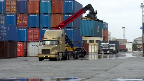 Reachstacker transports a container in front of a container warehouse. Stock Footage 148691938