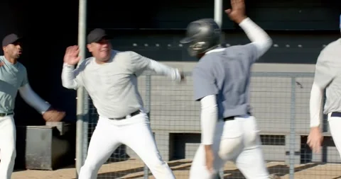 Reacting to close play, diverse baseball players running from dugout fence Stock Footage 341467033