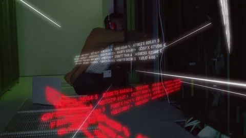 Reacting to moving data, tech in striped top red headset crouching in demo room Stock Footage 331872762