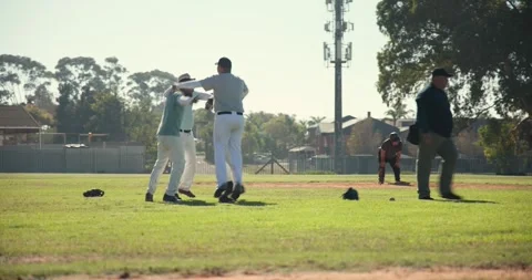 Reacting to throw, male baseball player catching ball on infield, then leading Stock Footage 338060222