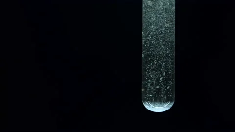 Reaction in water. Test tube. Dissolution of component. Stock Footage 238842017
