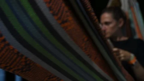 Read a book lying in the hammock on a summer night Stock Footage 127541642