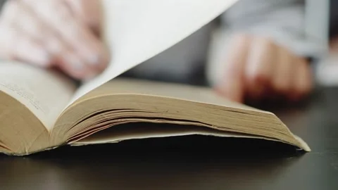 Read books in library. Studying of the scientific material. Person reads a book Stock Footage 200536607