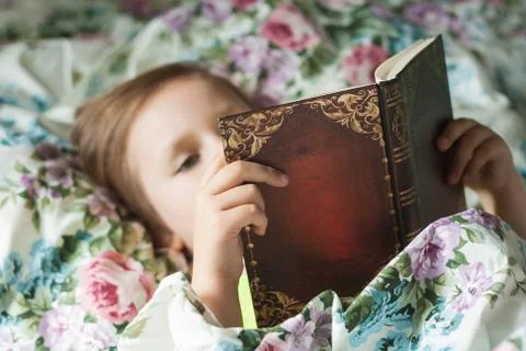 To read lying in a bed Stock Photos