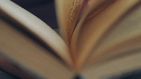 The reader of the book moves her fingers along the page while reading Video stock 76708398