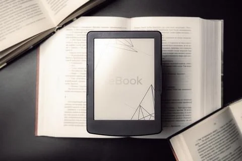 Readers. Digital e book, library reader tablet with books on dark background. Stock Photos