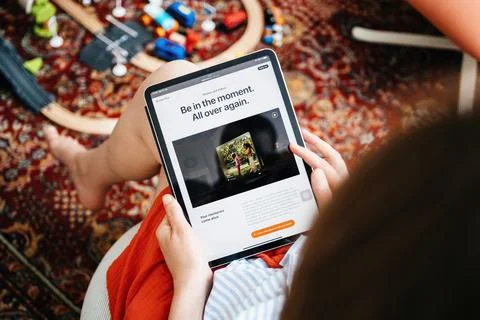 Reading About Apple Vision Pro on a Tablet 写真素材