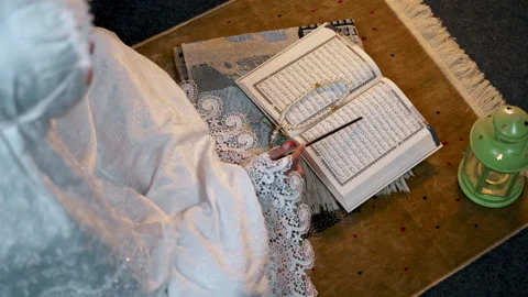 Reading Al Quran top down angle, camera tracking Stock Footage 264115091