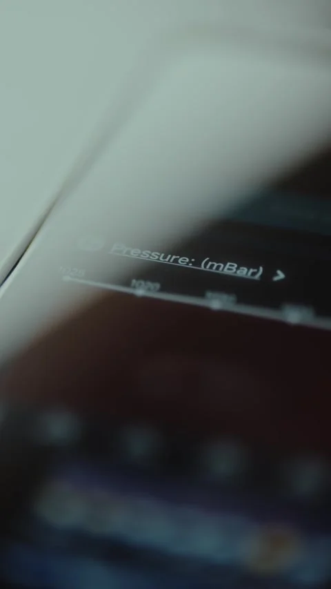 Reading for atmospheric pressure in millibars mBar on mobile phone screen Stock Footage 326880623