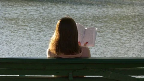 Reading on a background of water Stock Footage 75871379