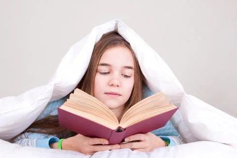 Reading in bed Stock Photos