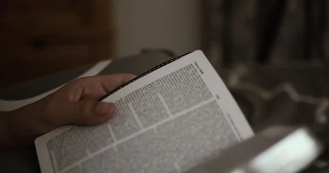 Reading Bible on Bed at Night, Handheld DCI 4K Stock Footage 99615800