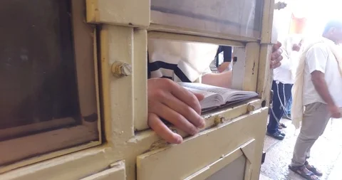 Reading the bible from a hole in the door Stock Footage 96004136
