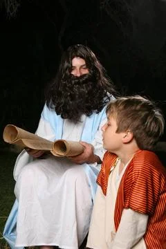Reading bible scroll or other scroll Man and boy dressed in biblical cloth... Stock Photos