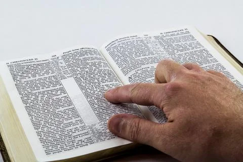 Reading a Bible on White Background. Stock Photos