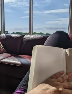 Reading with Blank Book in Daylight Stock Photos
