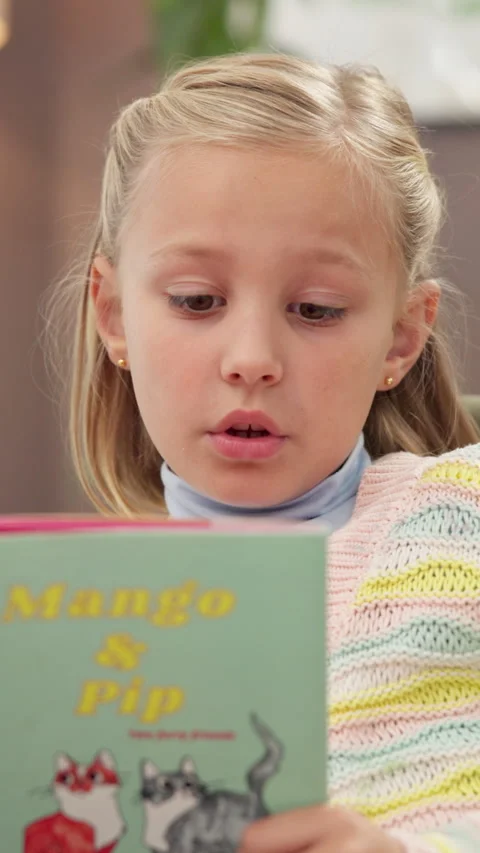 Reading, book and child on sofa at house for storytelling, learning and language Stock Footage 311481603