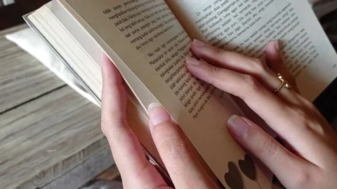 Reading a book and moving to the next page Stock Footage 137695536