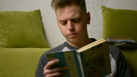 Reading a book and quickly turning backward pages in search for something 스톡 동영상 92991408
