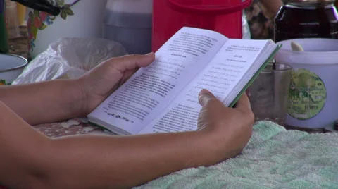 Reading a book at the bazaar in Uzbekistan Stock Footage 30363058