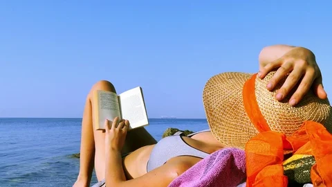 Reading a book at beach Stock Footage 78777538