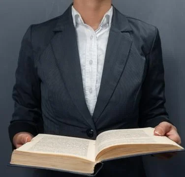 Reading a book at the blackboard Stock Photos