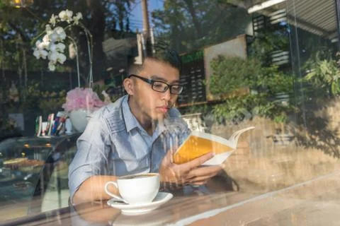 Reading book at cafe Stock Photos
