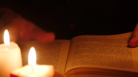 Reading book in darkness . Leaf through by hands 4k Stock Footage 45320127