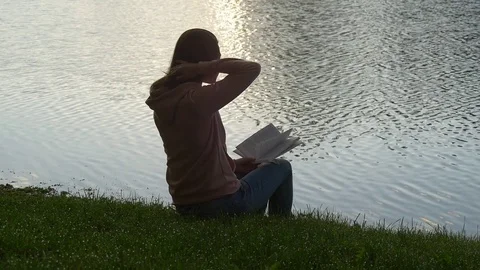 Reading a book at dawn Stock Footage 75869234