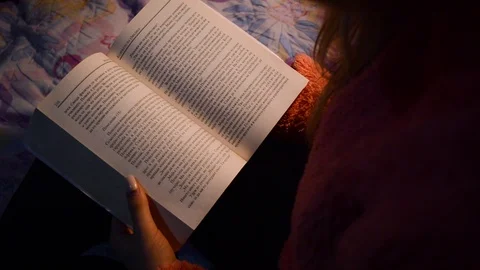 Reading a book on a dim light. Stock Footage 104763894