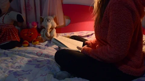 Reading a book on a dim light. Stock Footage 104764016