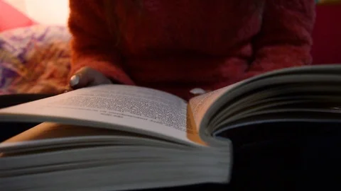 Reading a book on a dim light before sleeping. Stock Footage 104763899