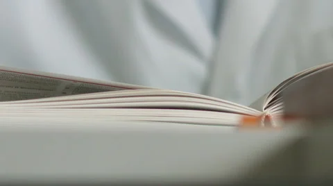 Reading the book, encyclopedia Video stock 64424227